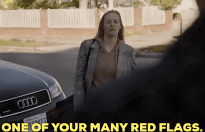 A Woman Is Standing In Front Of An Audi Car And Talking To A Man . GIF