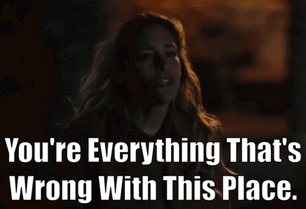 A Woman Is Standing In The Dark With The Words You 'Re Everything That 'S Wrong With This Place GIF