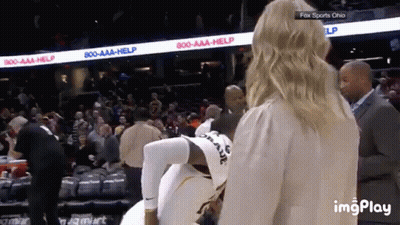 A Woman Is Standing Next To A Basketball Player In A Fox Sports Ohio Stadium GIF