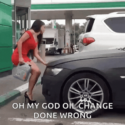 A Woman Is Standing Next To A Car At A Gas Station Holding A Can Of Oil . GIF