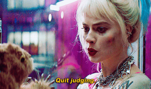 A Woman Is Standing Next To A Dog And Talking To It While Wearing A Necklace . GIF