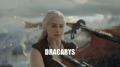A Woman Is Standing Next To A Dragon With The Word Dracarys Written On The Bottom . GIF