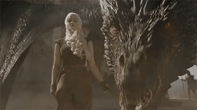 A Woman Is Standing Next To A Large Dragon With A Sword In Her Hand . GIF
