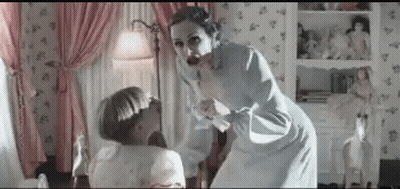 A Woman Is Standing Next To A Little Girl In A Room . GIF