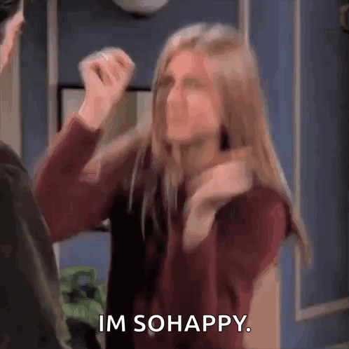 A Woman Is Standing Next To A Man And Making A Funny Face While Saying `` Im So Happy '' . GIF