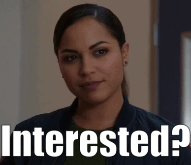 A Woman Is Standing Next To A Sign That Says Interested ? GIF
