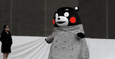 A Woman Is Standing Next To A Teddy Bear Wearing A Black And White Plaid Coat . GIF
