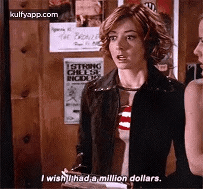 A Woman Is Standing Next To Another Woman In A Room And Talking To Her . GIF