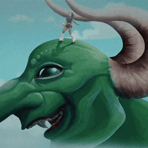 A Woman Is Standing On Top Of A Green Monster GIF