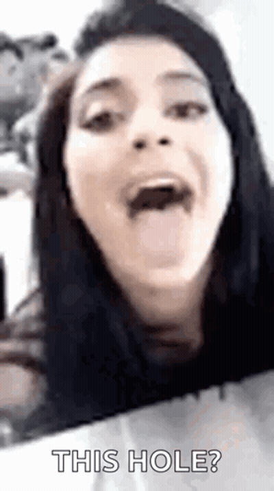 A Woman Is Sticking Her Tongue Out And Saying `` This Hole ? '' GIF