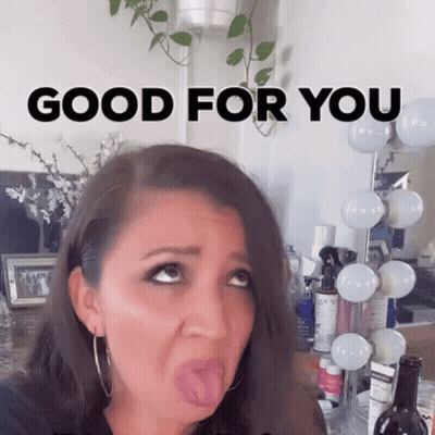 A Woman Is Sticking Her Tongue Out In Front Of A Mirror With The Words Good For You Written On It GIF