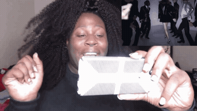 A Woman Is Taking A Picture Of A Group Of People GIF