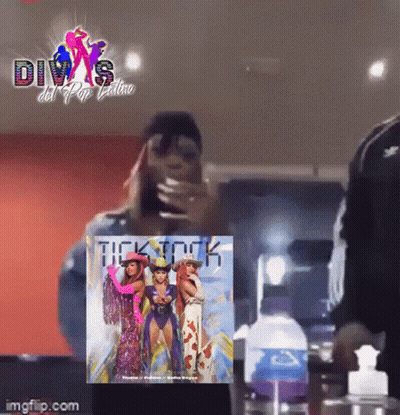 A Woman Is Taking A Picture Of Herself In Front Of A Poster That Says Divas Del Pop Latino GIF