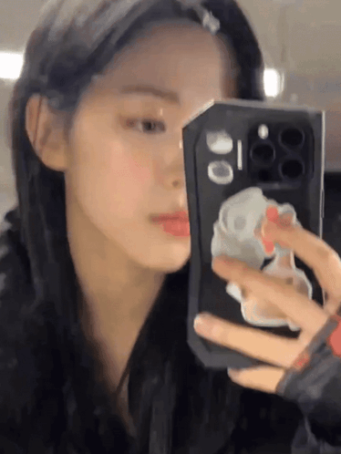 A Woman Is Taking A Picture Of Herself In The Mirror GIF
