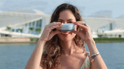 A Woman Is Taking A Picture Of Herself With A Camera GIF