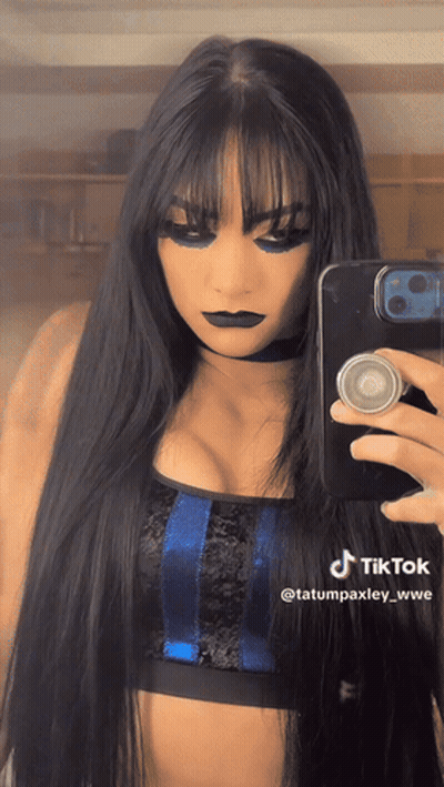 A Woman Is Taking A Picture Of Herself With A Tiktok Watermark GIF