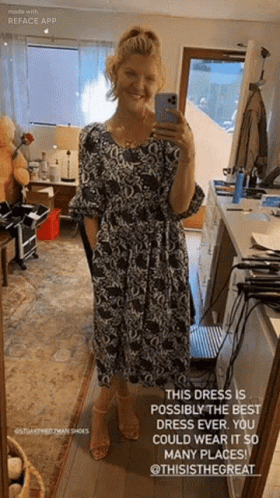 A Woman Is Taking A Selfie In Front Of A Mirror While Wearing A Black And White Dress GIF