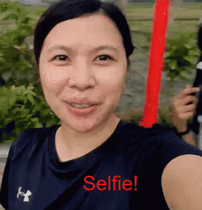 A Woman Is Taking A Selfie With The Words Selfie Written In Red GIF