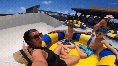 A Woman Is Taking A Selfie With Two Children On A Raft GIF