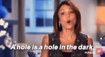 A Woman Is Talking About A Hole In The Dark While Wearing A Sequined Top . GIF