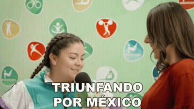 A Woman Is Talking Into A Microphone And The Words Triunfando Por Mexico Are On The Bottom GIF