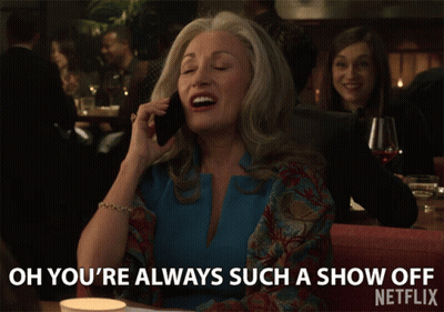 A Woman Is Talking On A Cell Phone And Says Oh You 'Re Always Such A Show Off GIF