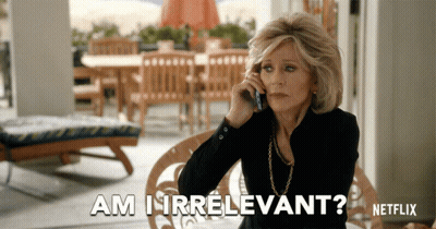A Woman Is Talking On A Cell Phone And The Words Am I Irrelevant Are Above Her GIF