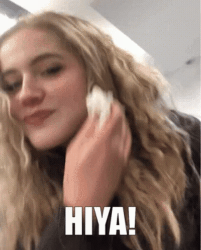 A Woman Is Talking On A Cell Phone And The Words Hiya Are On The Screen GIF
