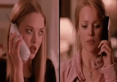 A Woman Is Talking On A Cell Phone Next To A Woman Talking On A Cell Phone . GIF
