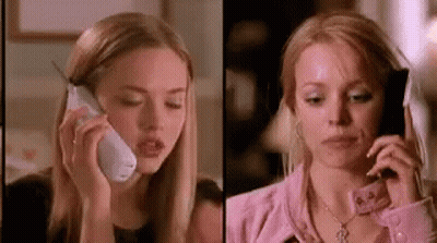 A Woman Is Talking On A Cell Phone Next To Another Woman . GIF