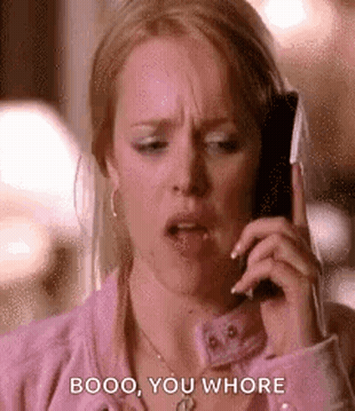 A Woman Is Talking On A Cell Phone While Making A Funny Face . GIF