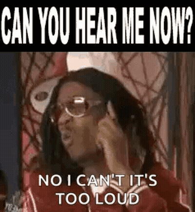 A Woman Is Talking On A Cell Phone While Wearing Glasses And A Red Jacket . GIF