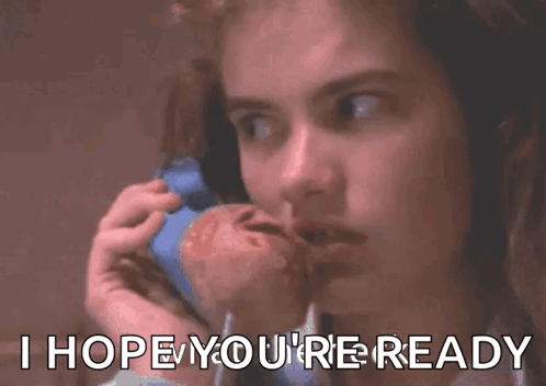 A Woman Is Talking On A Cell Phone With A Baby In Her Arms . GIF