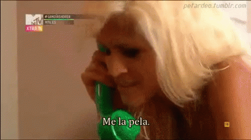 A Woman Is Talking On A Green Phone With The Words Me La Pela GIF