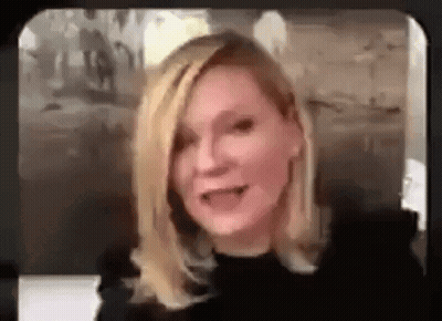 A Woman Is Talking On A Video Call While Wearing A Black Top . GIF