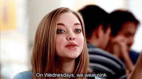 A Woman Is Talking To A Group Of People And Says `` On Wednesdays , We Wear Pink '' . GIF