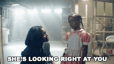 A Woman Is Talking To A Little Girl Who Is Looking Right At Her . GIF