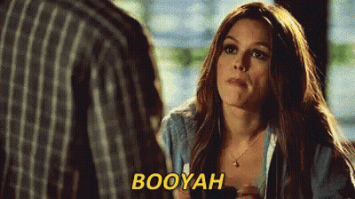 A Woman Is Talking To A Man And The Word Booyah Is Visible GIF