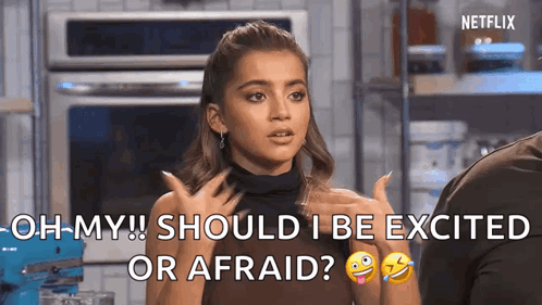 A Woman Is Talking To A Man In A Kitchen And Says `` Oh My Should I Be Excited Or Afraid '' . GIF