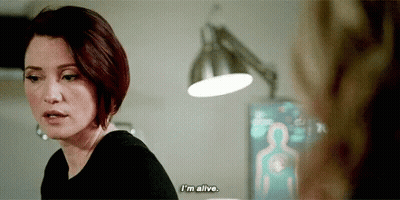 A Woman Is Talking To Another Woman In A Room And Says `` I 'M Alive . '' GIF