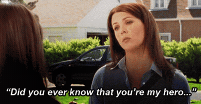 A Woman Is Talking To Another Woman In Front Of A Car And Says `` Did You Ever Know That You 'Re My Hero . '' GIF