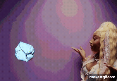 A Woman Is Throwing A Ball In The Air . GIF
