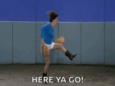A Woman Is Throwing A Baseball With The Words `` Here Ya Go '' Written Next To Her . GIF