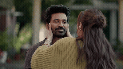 A Woman Is Touching A Man 'S Face In A Close Up . GIF