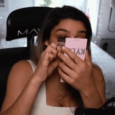 A Woman Is Using A Kylie Eyelash Curler On Her Eye GIF