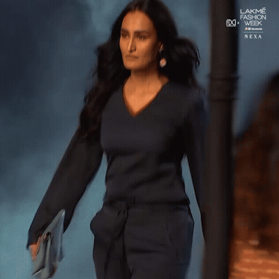 A Woman Is Walking Down The Runway At The Lakme Fashion Week GIF