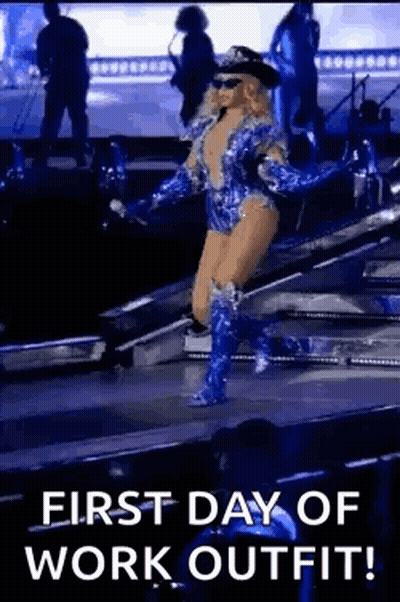 A Woman Is Walking On A Stage Wearing A Police Uniform And Boots . GIF