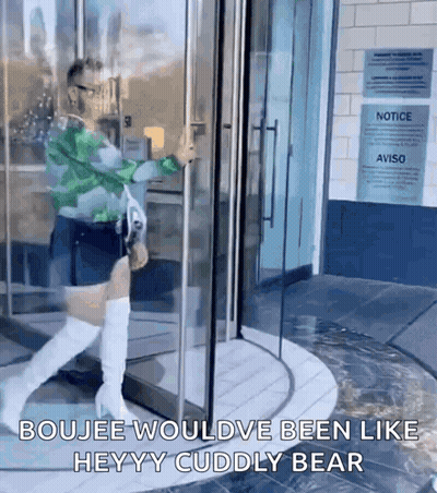 A Woman Is Walking Through A Glass Door With The Words Boujee Wouldve Been Like Heyy Cuddly Bear On The Bottom GIF