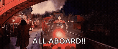 A Woman Is Walking Towards A Train With The Words All Aboard On The Bottom GIF