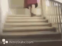A Woman Is Walking Up A Set Of Stairs With Retrostatic.com Written On The Bottom . GIF